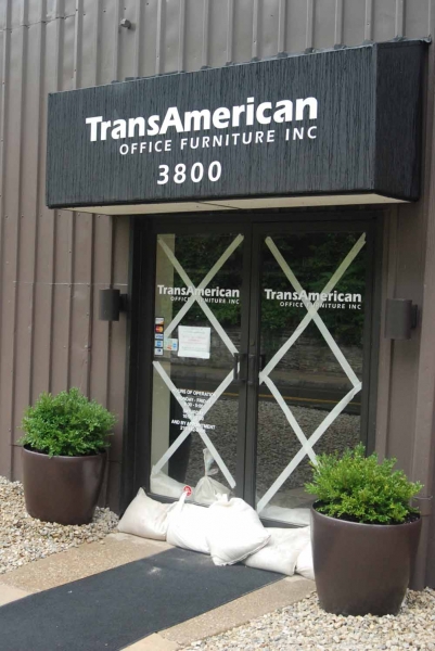 Sandbags sit at the front door of a furniture store on Main Street (Max Matza/for NewsWorks) 