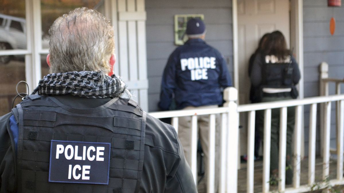  In this Feb. 9, 2017, photo provided U.S. Immigration and Customs Enforcement, ICE agents at a home in Atlanta, during a targeted enforcement operation aimed at immigration fugitives, re-entrants and at-large criminal aliens. (Bryan Cox/ICE via AP) 