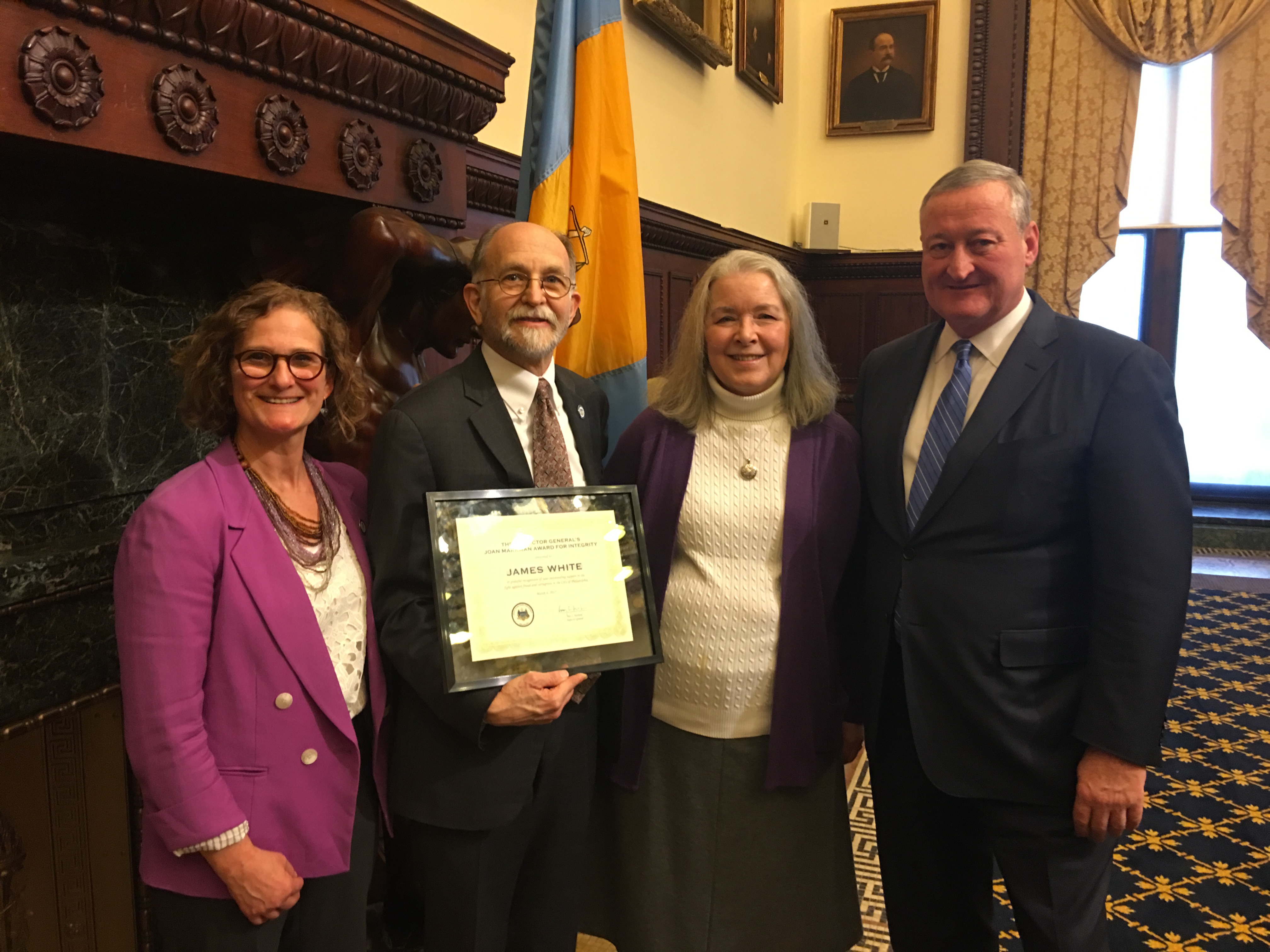  Jim White (center) receives the 2017 Joan Markman Award for Integrity flanked by his wife, Clare Bohn, Mayor Jim Kenney and Inspector General Amy Kurland (left). (Tom MacDonald/WHYY) 