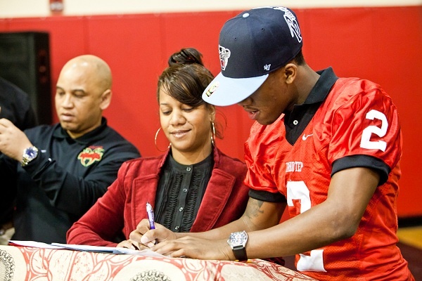 <p><p>Najee Goode and his mother Felicia stand at the podium as he formally commits with the University of Maine. (Brad Larrison/for NewsWorks)</p></p>
