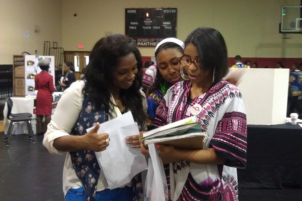 <p><p>Sophomores Mya Kitchen and Deja Bagby get help on "The Great Condom Race" game from education coordinator Kamela Jefferson. (Yasmein James/for NewsWorks)</p></p>
