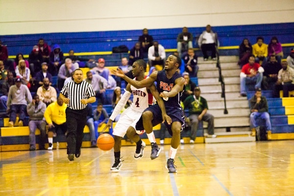 Hakkeem Baxter of Philadelphia Electrical gets tripped up while trying to strip the ball from Abraham Massaley of Imhotep. (Brad Larrison/for NewsWorks)
