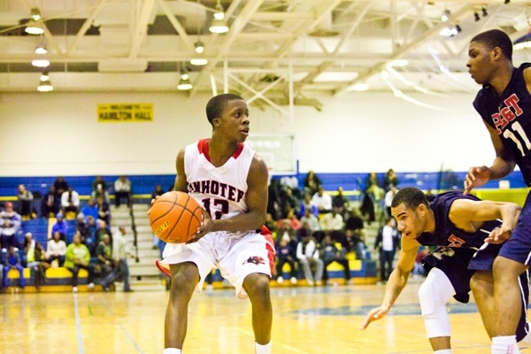 Double-teamed, Imhotep's Jakwan Jones looks for an open teammate in action against Philadelphia Electrical. (Brad Larrison/for NewsWorks)
