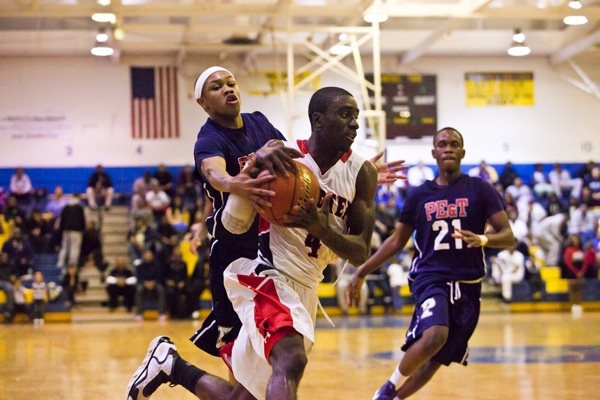 Khaalis Carter of Philadelphia Electrical tries in vain to strip the ball from Imhotep Guard Abraham Massaley. (Brad Larrison/for NewsWorks)

