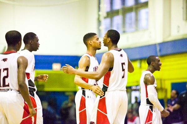 Nigel Grant and Basil Thompson of Imhotep hug after a timeout was called with less than a minute left in the fourth quarter. (Brad Larrison/for NewsWorks)
