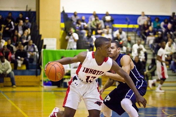 Imhotep Guard Jakwan Jones gets past Steve Griffin of Philadelphia Electrical and Technology Charter School to help lead Imhotep to a 51-43 win in the Public League playoffs Saturday. (Brad Larrison/for NewsWorks)
