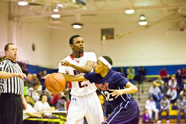 Khaalis Carter of Philadelphia Electrical tries to strip the ball from Imhotep Guard Deryl Bagwell. (Brad Larrison/for NewsWorks)

