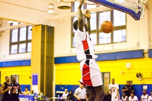 Brandon Austin of Imhotep seals the deal and dunks the ball with only a few seconds left in regulation. Imhotep topped Philadelphia Electrical 51-43 on Saturday. (Brad Larrison/for NewsWorks)
