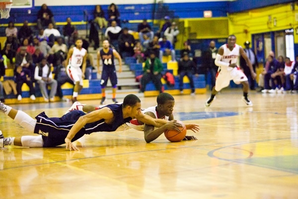 Jakwan Jones (Imhotep) and Steve Griffin (Electrical) dive for a loose ball during Saturday's quarterfinals. (Brad Larrison/for NewsWorks)
