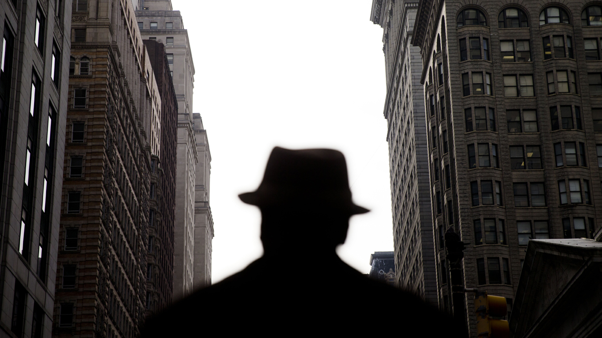  A new report says only the top 1 percent of Pennsylvanians have seen income gains since 2009. A man waits to cross the street near City Hall in Philadelphia. (AP File Photo/Matt Rourke)  