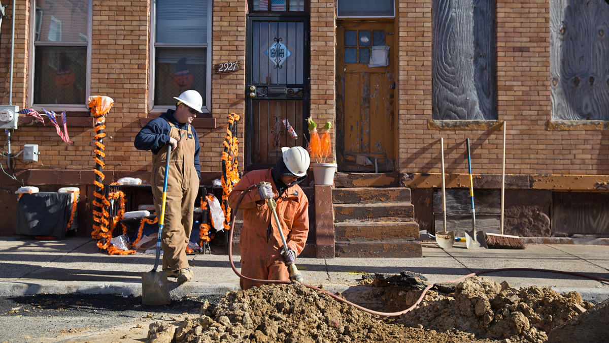  Kevin McDonald, PGW Senior Pipe Mechanic uses a compressor to back fill soil covering new natural gas pipelines after an aging cast iron main was turned off in North Philadelphia. (Lindsay Lazarski/WHYY) 