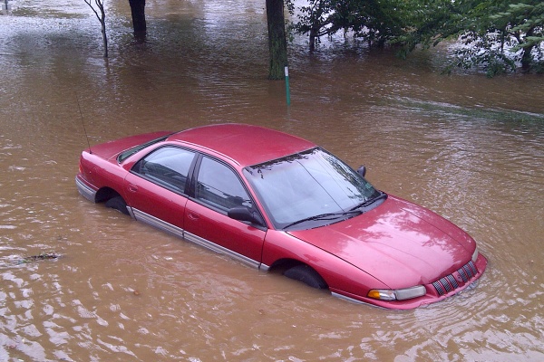 A car, stuck in flood water, was left abandoned without tages on East River Road. (Brian Hickey/For NewsWorks)