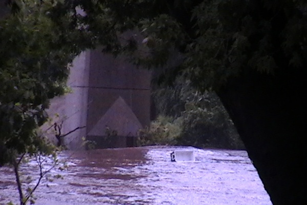 A large cooler can be seen in the center of the picture as it is carried by the current of the Schuylkill River. (Brian Hickey/For NewsWorks)