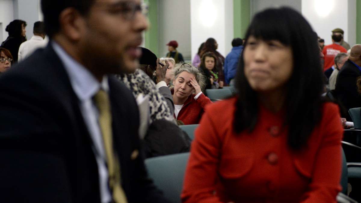 Traditional public school advocate Alison McDowell wearily reacts to the SRC's decision to move forward with charter conversion at Wister. (Bastiaan Slabbers for WHYY)