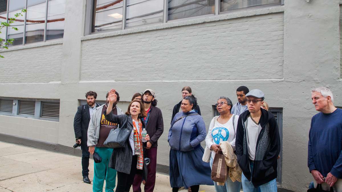 Drexel University Architect Nancy Rogo Trainer speaks to Jane's Walk participants about The Summit, a high rise student apartment building with ground floor retail space, near the terminus of Lancaster Avenue in University City.