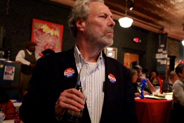 <p>A voter closely monitors the latest incoming election results.  ( Jana Shea /for NewsWorks )</p>
