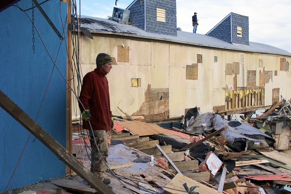 <p>Two of the many volunteers who are helping to restore the shore take a look out at the monumental task ahead of them. ( Jana Shea /for NewsWorks )</p>

