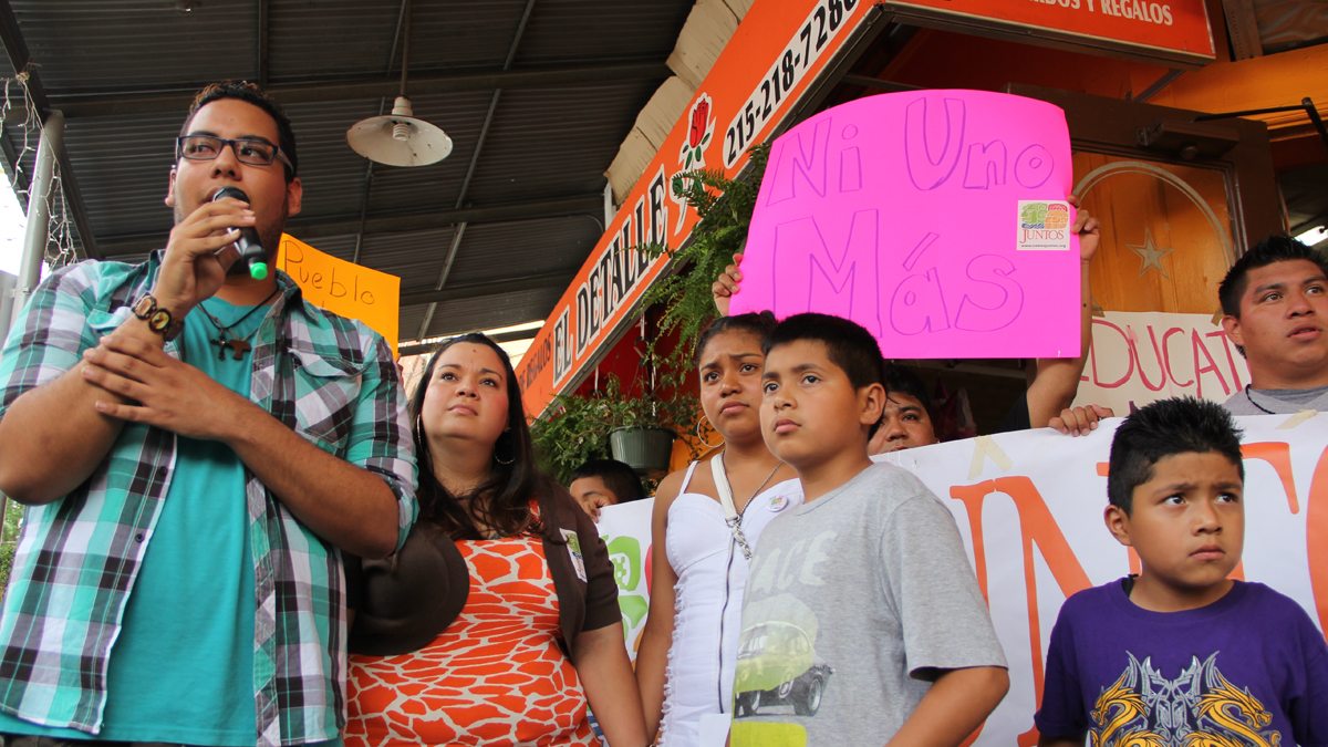 Miguel Andrade of Juntos translates during a press conference where adults and children from South Philadelphia's Latino community spoke about the way they were treated by law enforcement officers during recent raids. (Emma Lee/for NewsWorks) 