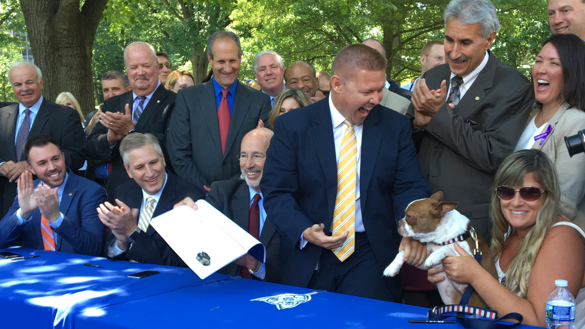  Libre calmly surveyed a cheering crowd after marking the (ceremonial) bill with his paw print. (Katie Meyer/WITF) 