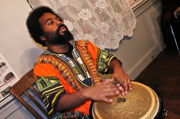 <p><p>Levi Joynes, a percussionist with Temple University's Pan-African Studies Community Education Program (PASCEP), drums at the Johnson House Kwanzaa celebration on Thursday night. (Kimberly Paynter/WHYY)</p></p>
