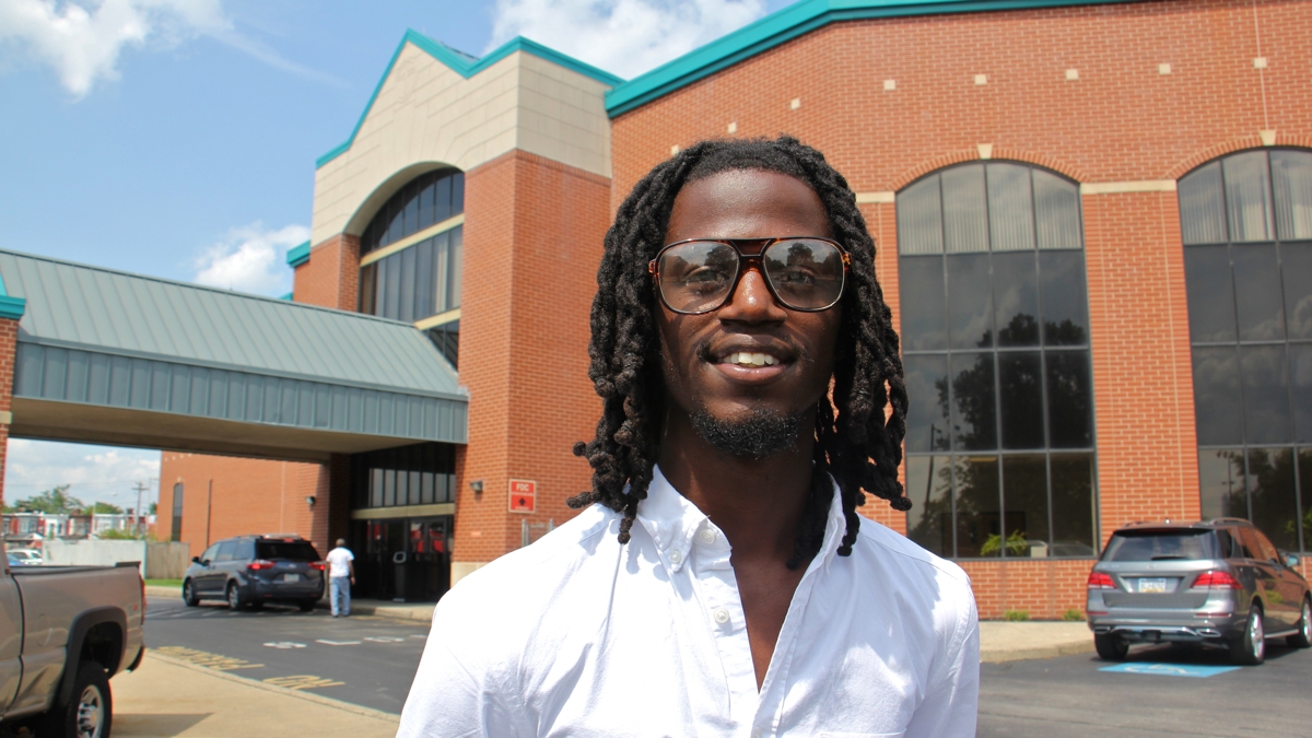 Elijah Clay stands outside the Deliverance Evangelistic Church in North Philadelphia, where he works and studies theology.