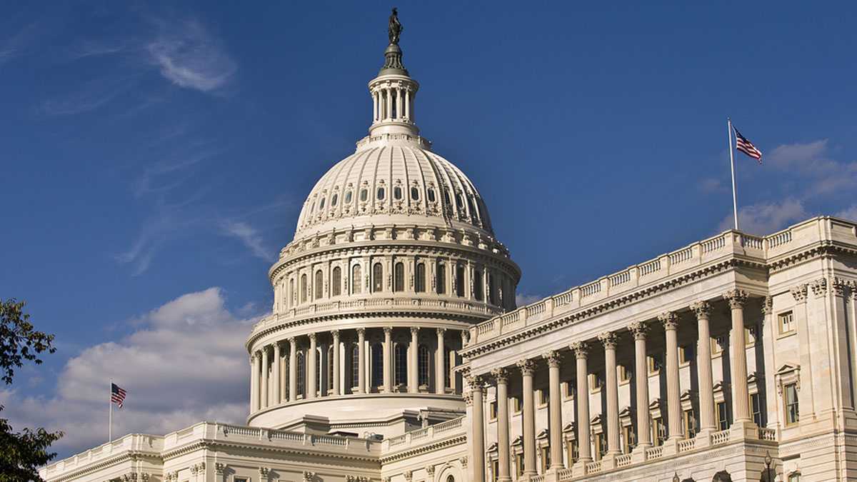 The United States Capitol building against a blue sky