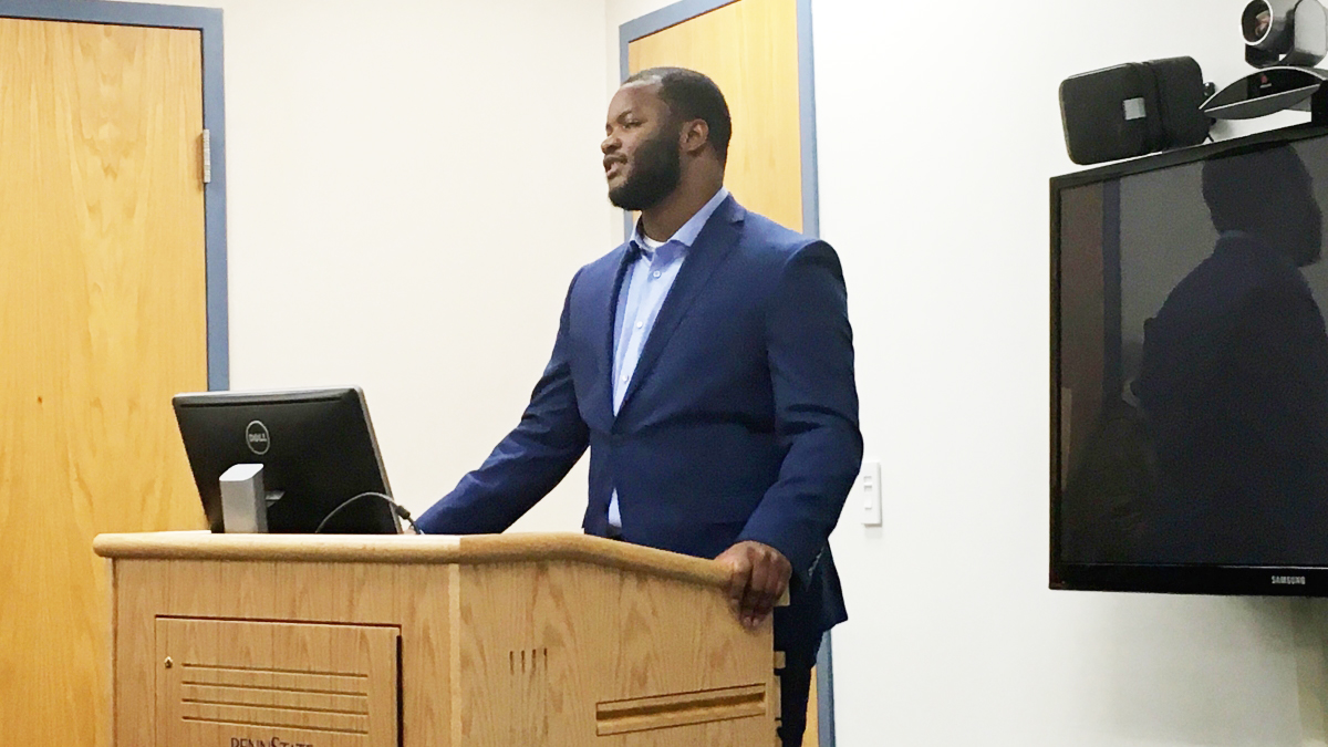  Penn State junior Brian Davis addresses a small group of people who have 