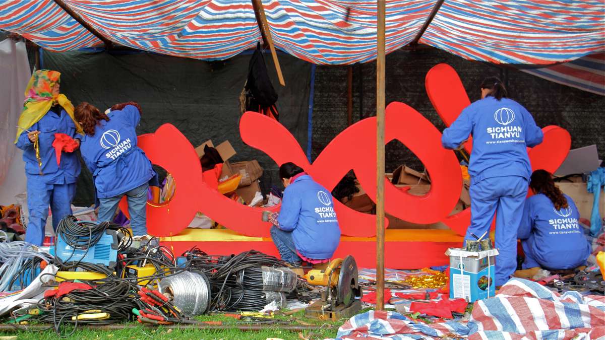 In a makeshift tent in a corner of Franklin Square, work continues on smaller lanterns, sculpted from steel frames and silk.