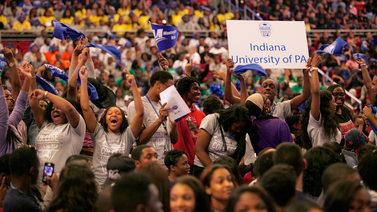  Students accepted at Indiana University of Pennsylvania jump up and cheer when their school is called during Mastery Charter College Signing Day. (Nathaniel Hamilton/for Newsworks) 