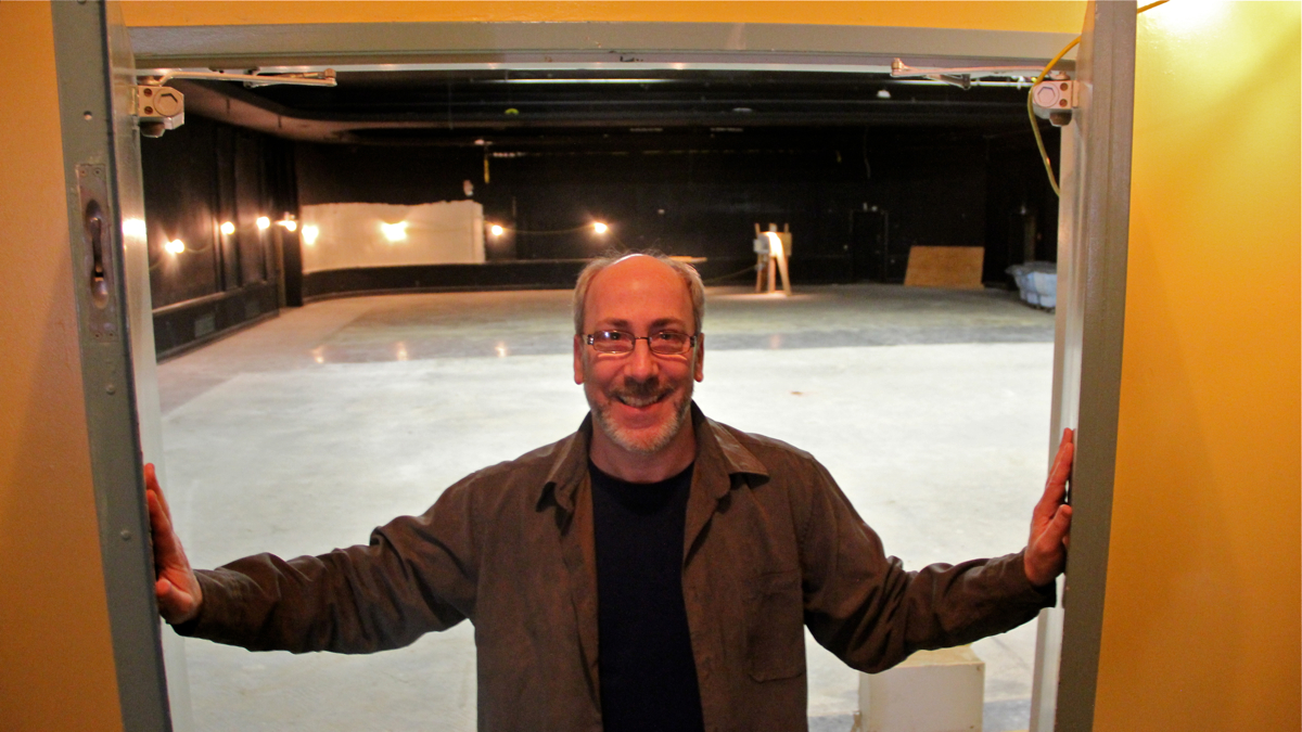 Seth Rozin, artistic director of InterAct, opens the doors to the long disused Drake Hotel ballroom, which will soon be converted into a theater. (Emma Lee/WHYY)