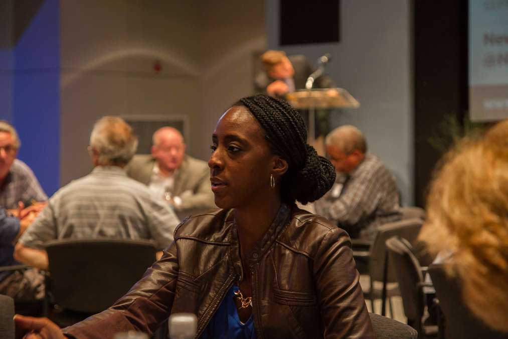 .Audience members wrap up their small-group discussions before beginning the open forum