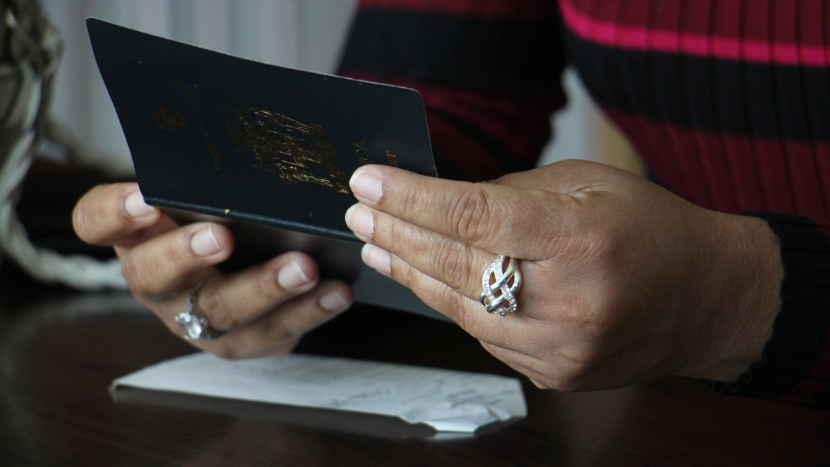  Tanesha holds her Jamaican passport. (Emma Lee/WHYY) 