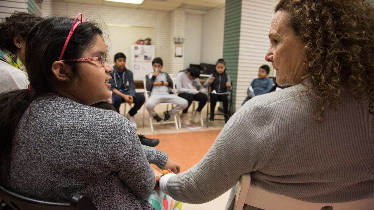 Instructor Nora Litz (right) listens as Sophia, 9, participates in a discussion during a workshop at Philadelphia nonprofit Mighty Writers.
