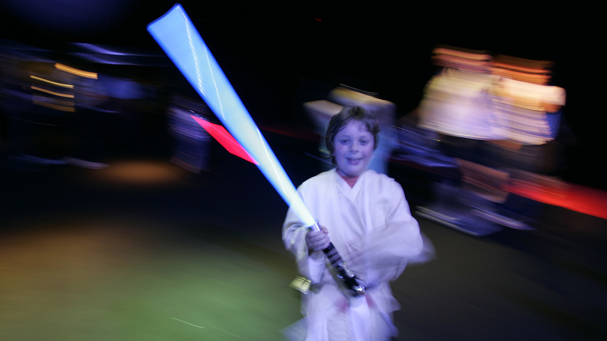  A young boy is shown holding his light sabre at a 2007 Star Wars-themed event in London. (AP Photo/Alastair Grant, file) 