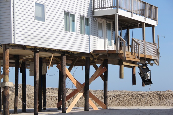 <p><p>A gas grill dangles from the remains of a porch on a beach-front home on Bay Avenue in Holgate, N.J. (Emma Lee/for NewsWorks)</p></p>
