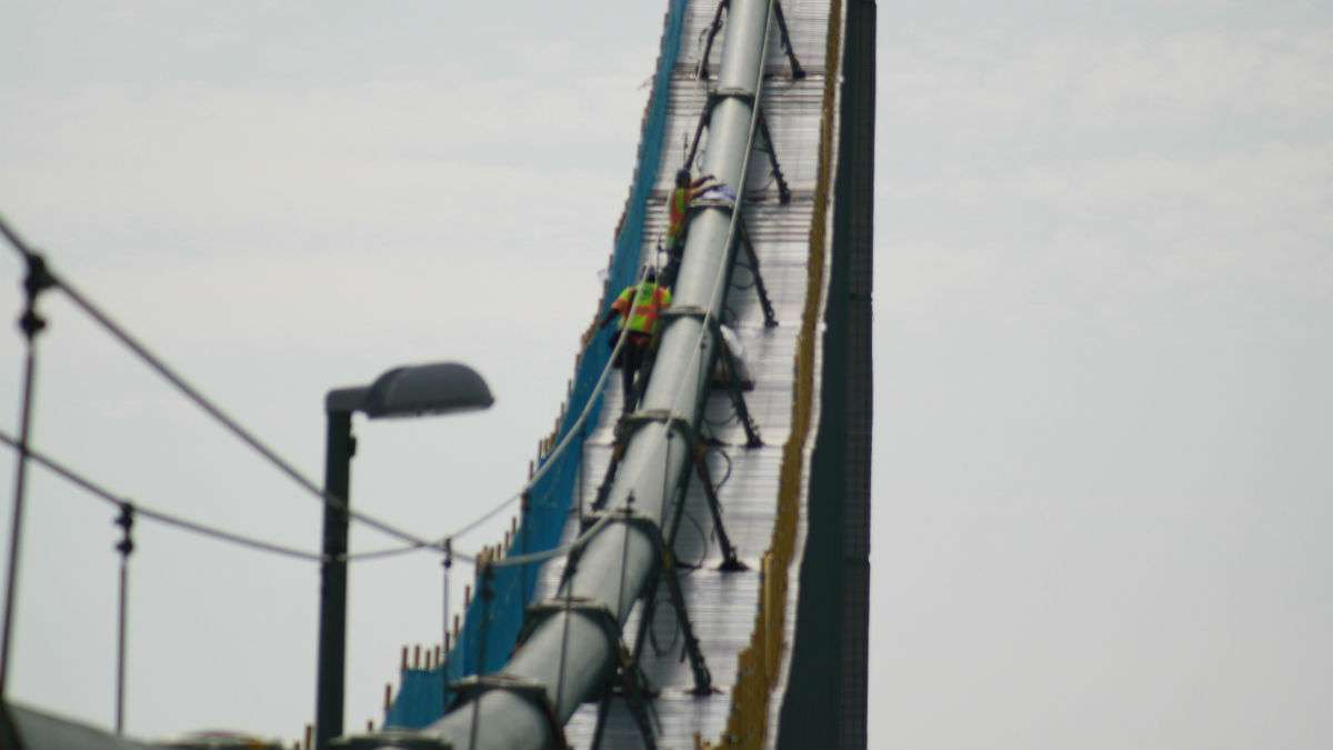 Workers wrapped the main cables of the Delaware Memorial Bridge before installing a dehumidification system to prevent corrosion. (Mark Eichmann/WHYY)