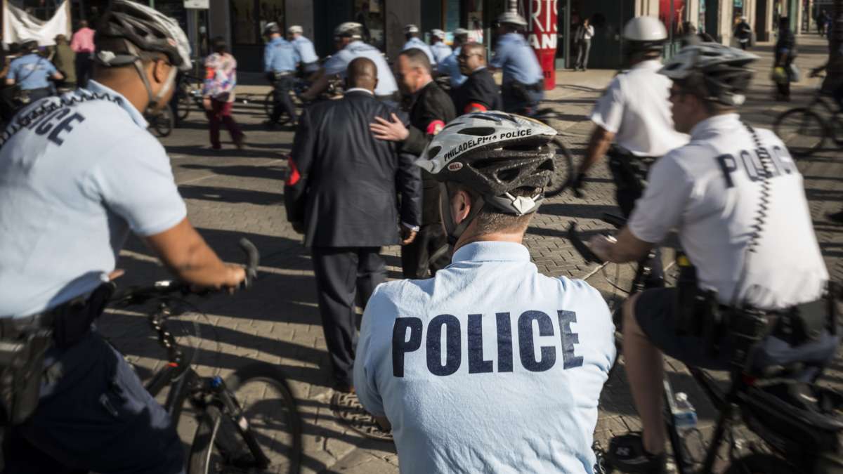 A portion of the more than 20 police officers at the rally steer marchers toward South Street.
