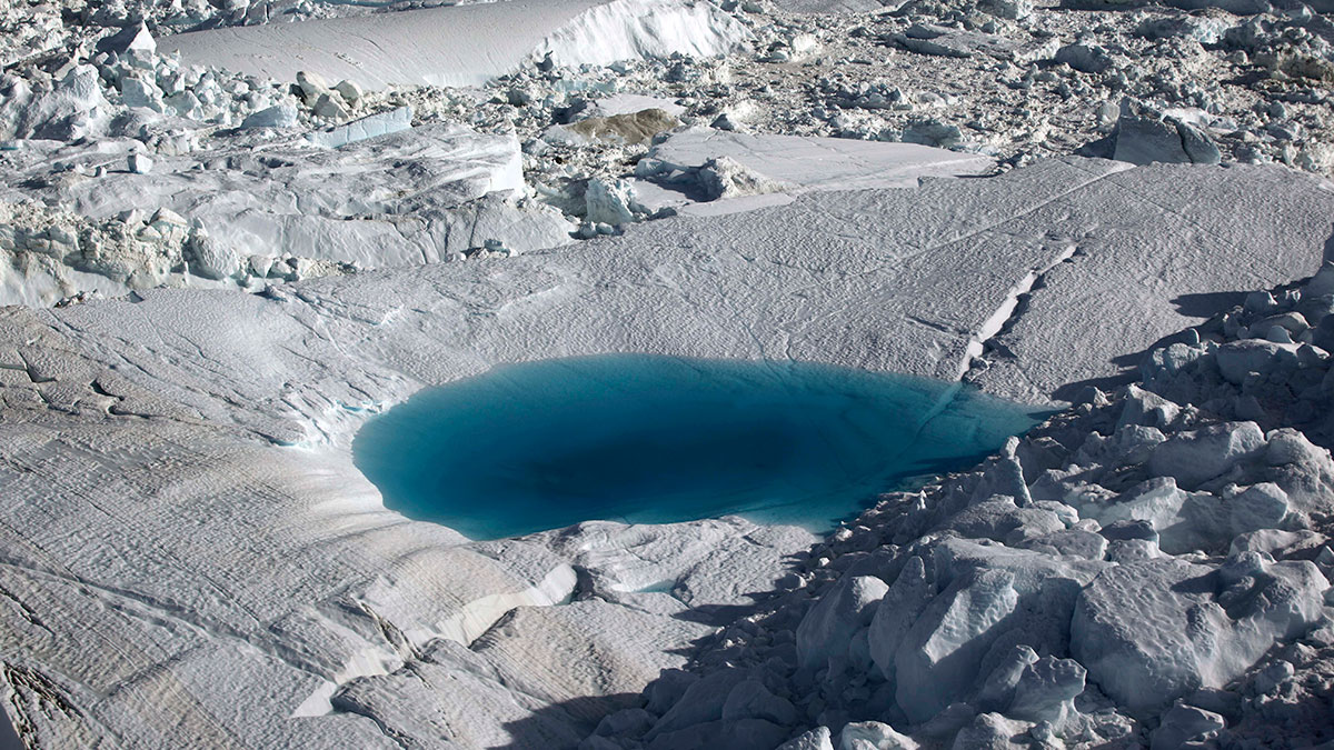  n this July 19, 2011 photo, a large melt pool forms in the Ilulissat ice fjord below the Jakobshavn Glacier, at the fringe of the vast Greenland ice sheet. (AP Photo/Brennan Linsley) 