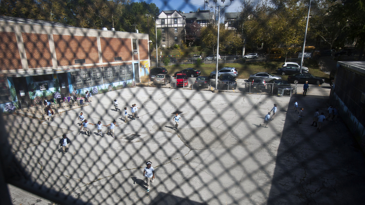  Students play in a bare lot with asphalt patches during recess at Anna Lane Lingelbach Elementary School in Philadelphia. (Photograph by Jessica Kourkounis) 