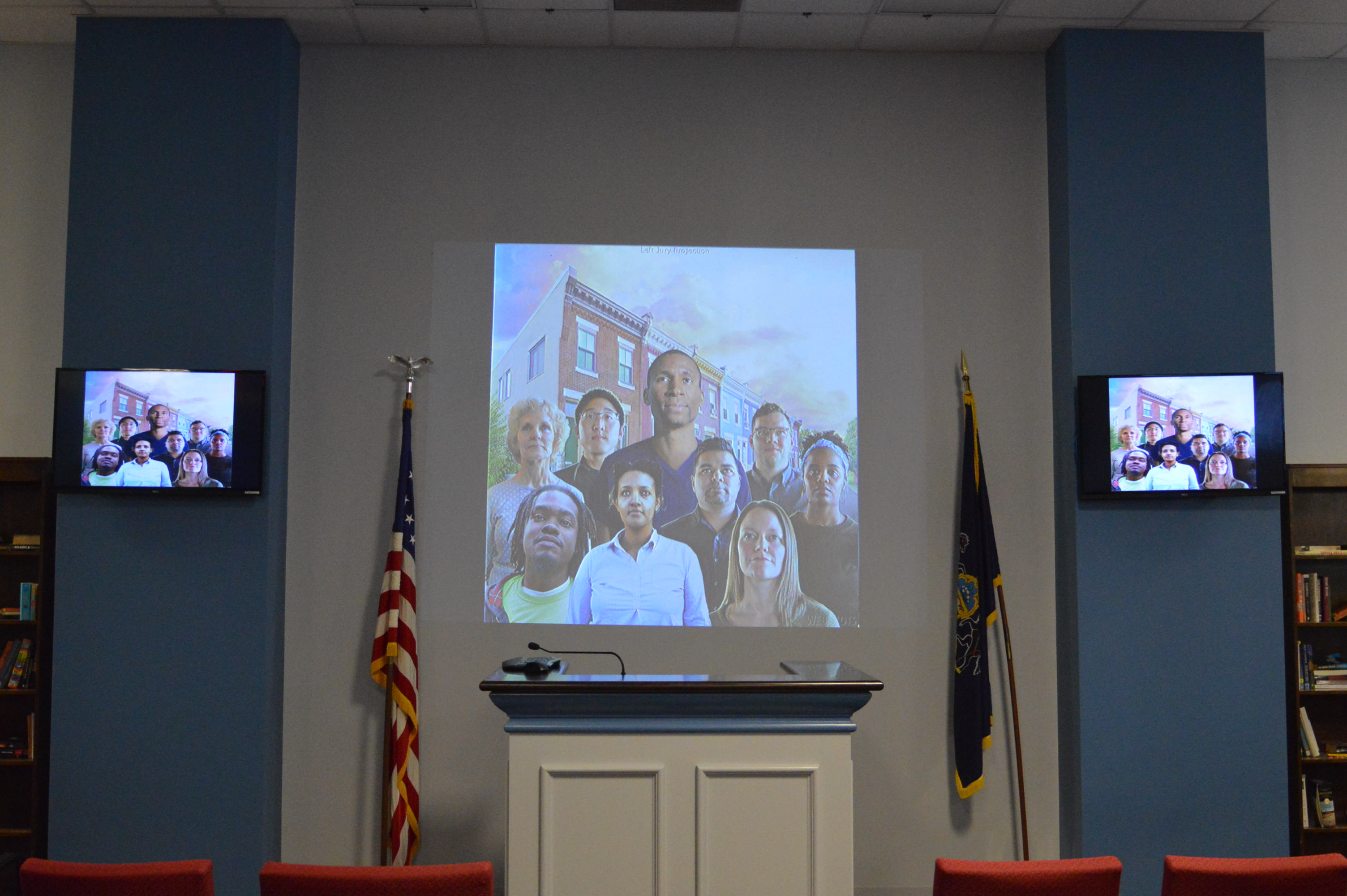  A projection on the wall shows one of the murals that will be painted in the Civil Jury Room at Philadelphia City Hall. (Tom MacDonald, WHYY) 