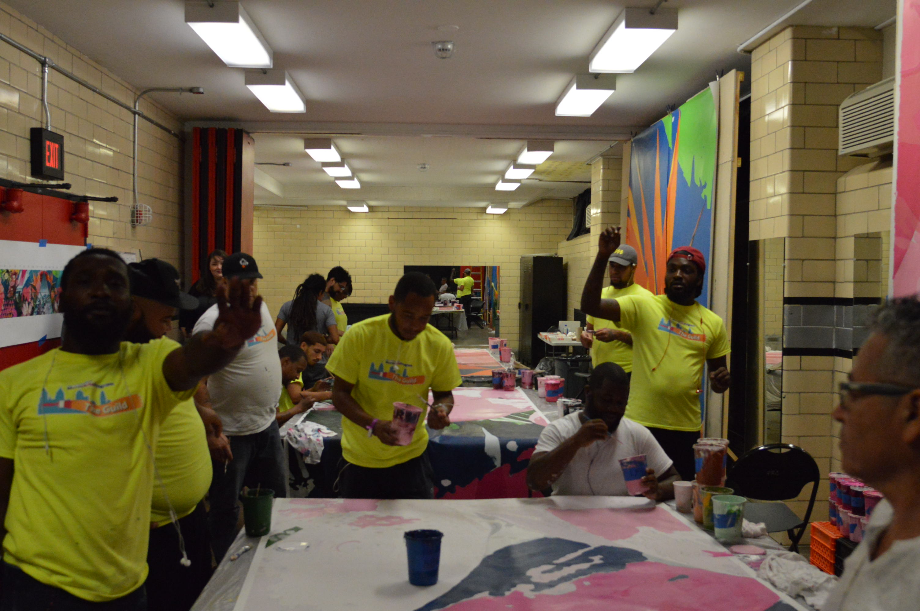  Artists work on the mural at Feltonville Recreation Center. (Tom MacDonald/WHYY) 
