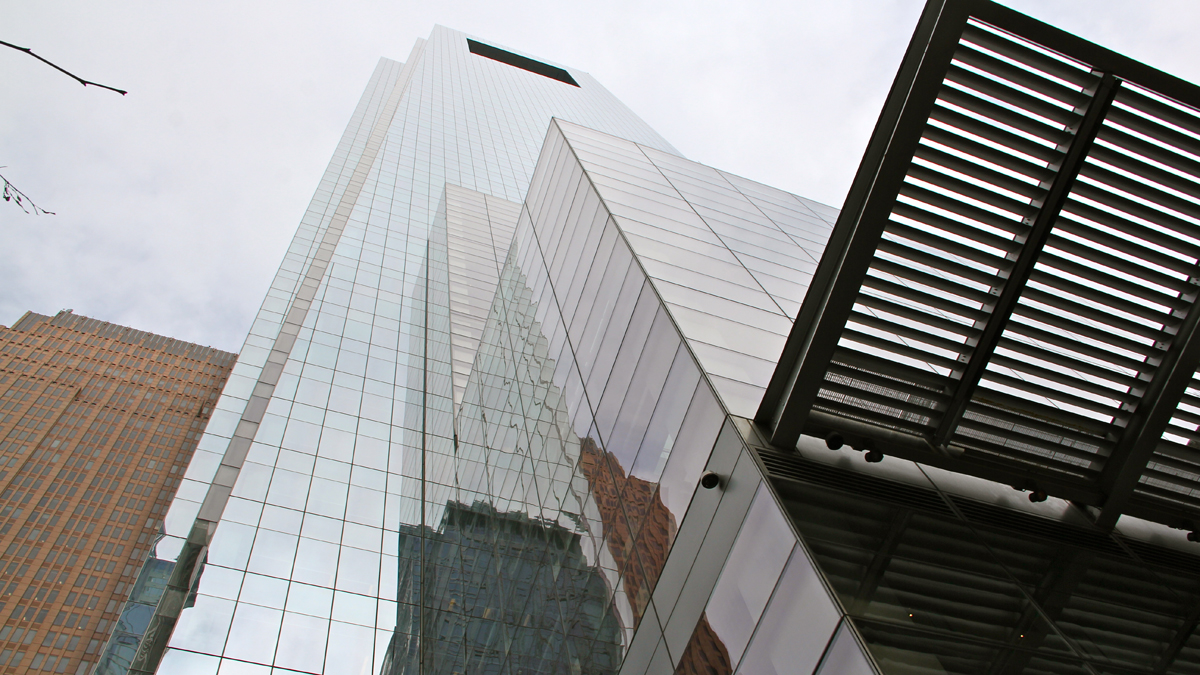 Hulking grey mirrored tower against a grey sky