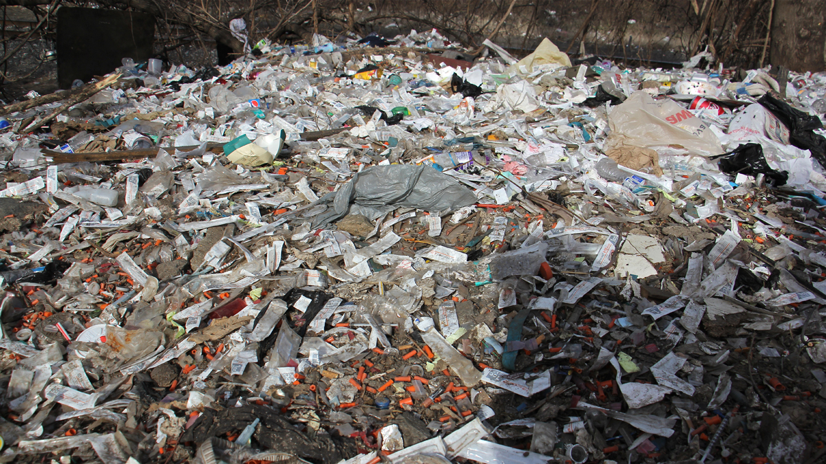 Heroin needles and trash litter the ground Conrail's railroad tracks in the Kensington neighborhood of Philadelphia (Emma Lee/WHYY)