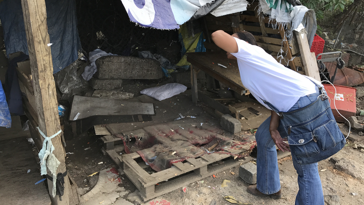 Asteria Vives peers into the shack that served as the 