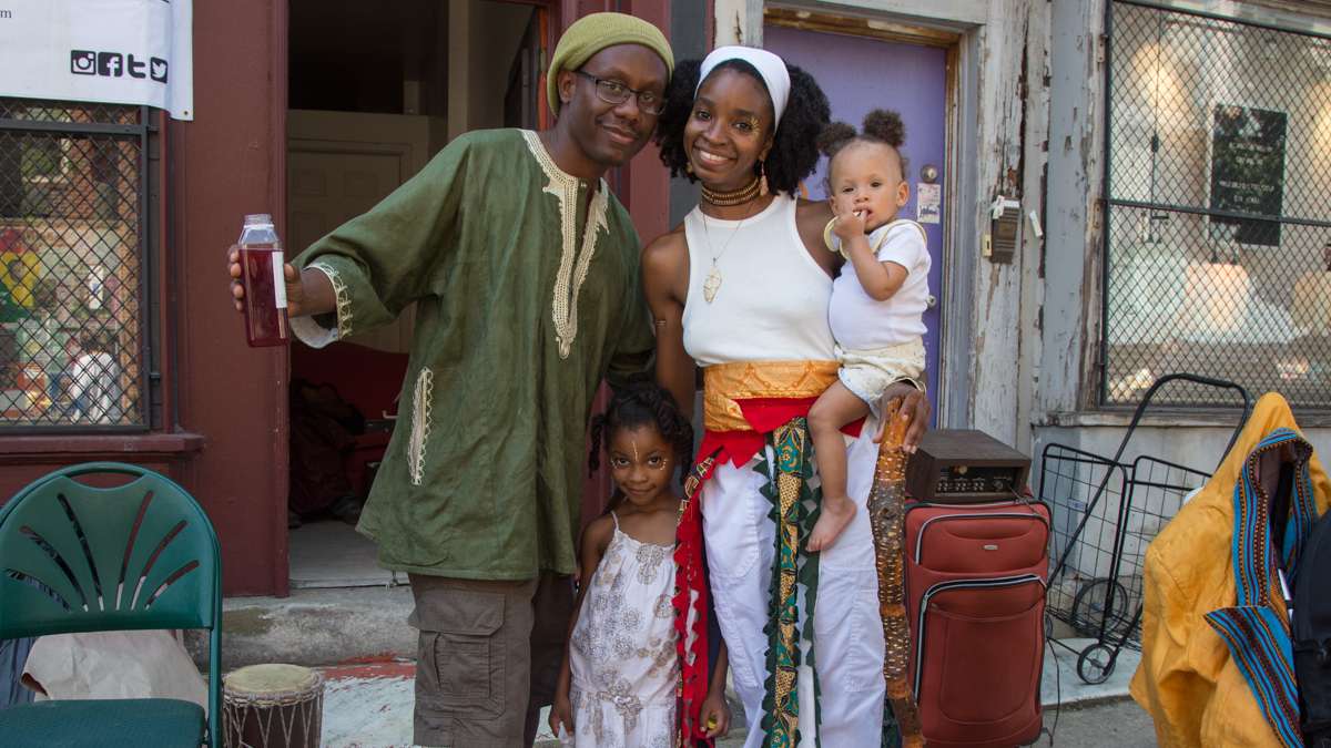 Ebony Zuudia stands with her two daughters, Ynobe, 4, and Auset,1, and brother Shalamar Bey. They work for the Drop Squad Kitchen, a vegan restaurant in Wilmington, Delaware, a vendor at the Odunde festival.