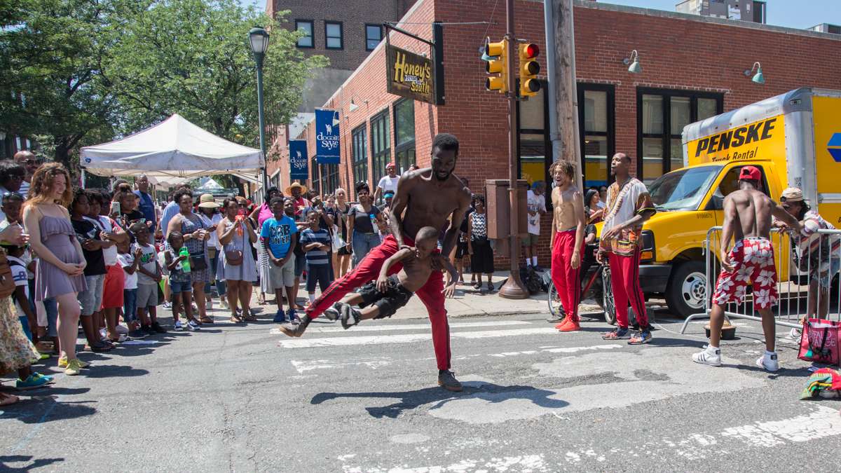 Antiwane Freeman, of Dancers Inspired Visions United, dances with his son A'shan, 5, during the 42nd Annual Odunde Festival.