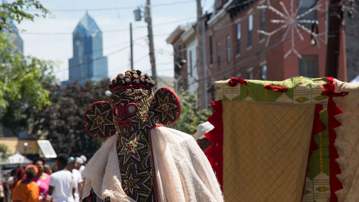 A physical representation of Egungun, or ancestors, dances in the procession toward the Schuylkill River to bring offerings to the Nigerian river goddess at the begining of the Philadelphia Odunde Festival.
