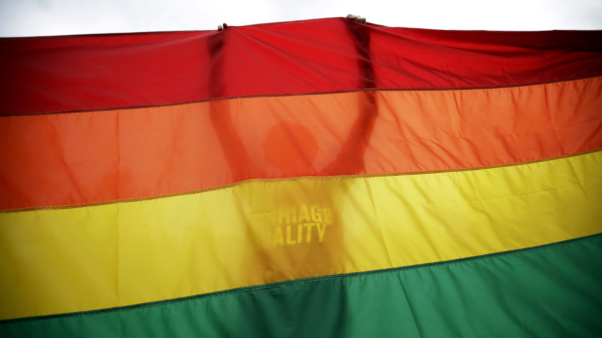  Sean Lewrence, of Philadelphia, holds up a flag during a rally for gay marriage, Wednesday, June 26, 2013, on Independence Mall in Philadelphia. Despite the Supreme Court's decision, gay marriage bans still stand in Pennsylvania and roughly three dozen other states. (AP Photo/Matt Slocum, file) 
