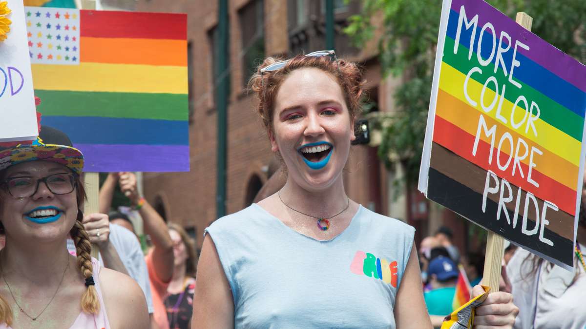 A marcher uses the newly adopted, Philly-introduced pride flag the 2017 Philadelphia Pride Parade, Sunday, June 18, 2017.
