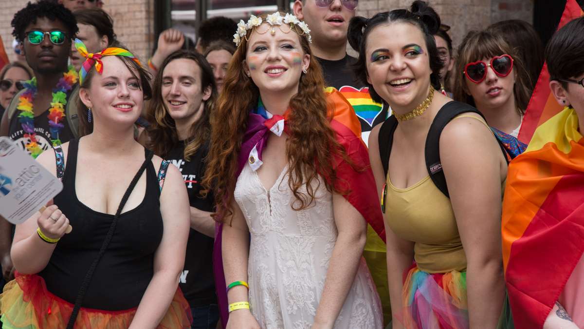 Revelers watch as floats pass at the 2017 Philadelphia Pride Parade, Sunday, June 18, 2017.